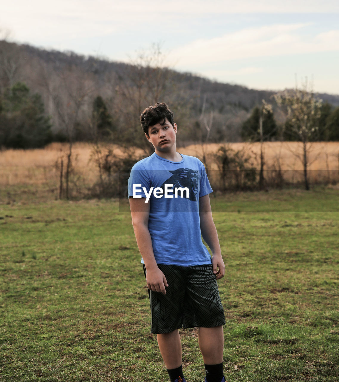 FULL LENGTH OF BOY STANDING ON LAND