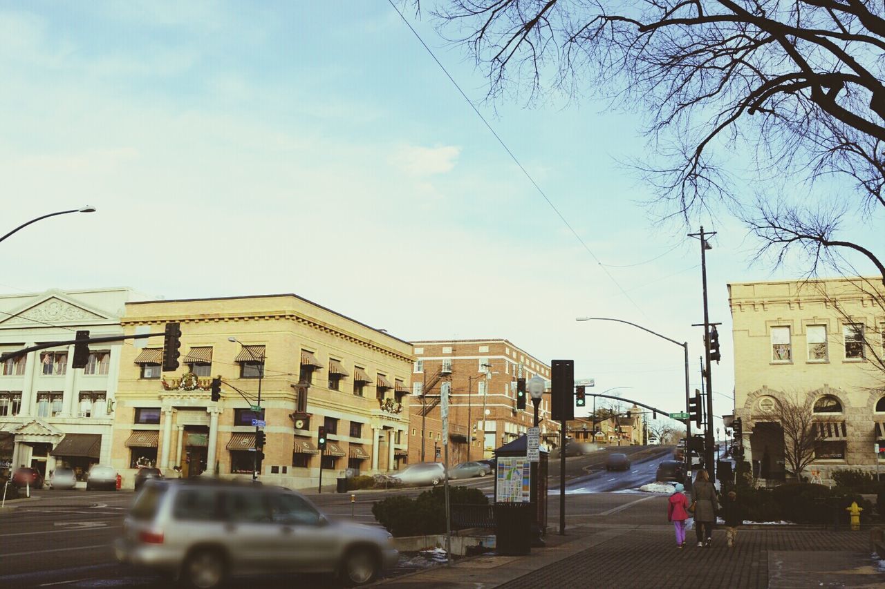 Blurred motion of car moving on city street against sky