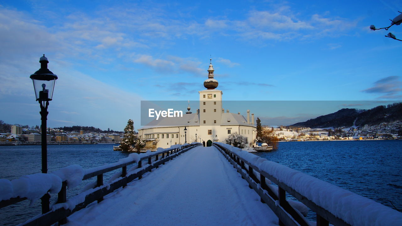 Snow covered buildings against sky