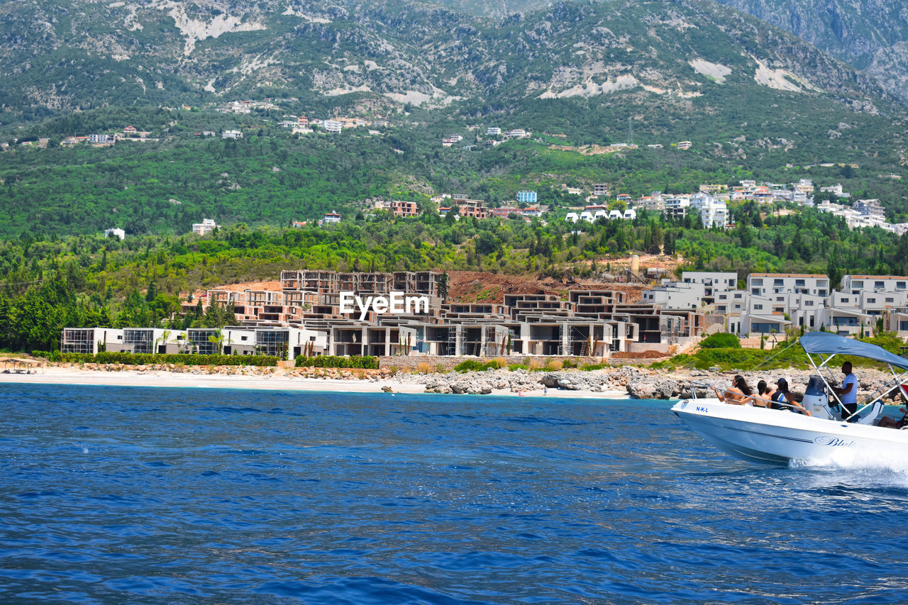 Scenic view of sea against buildings