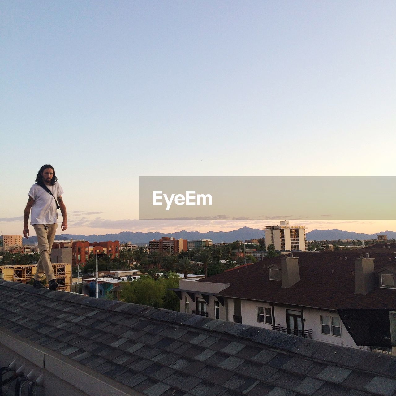 Man walking on rooftop 