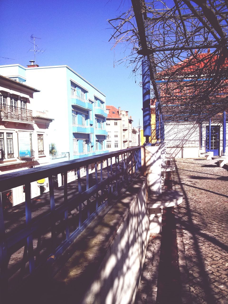 Walkway leading towards buildings in city