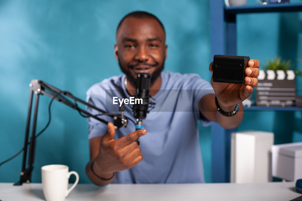 midsection of young man using mobile phone