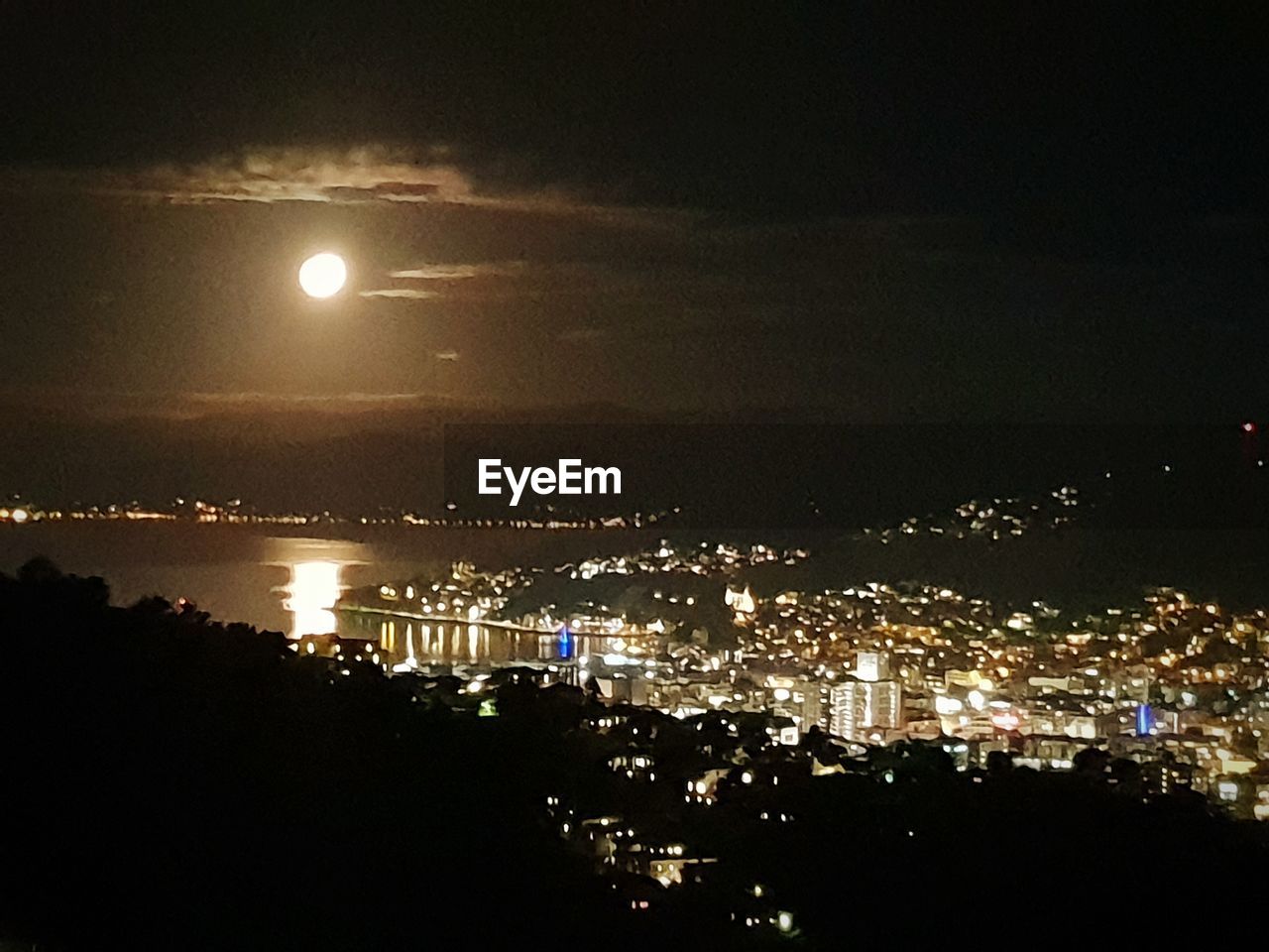 HIGH ANGLE VIEW OF ILLUMINATED CITY BUILDINGS AT NIGHT