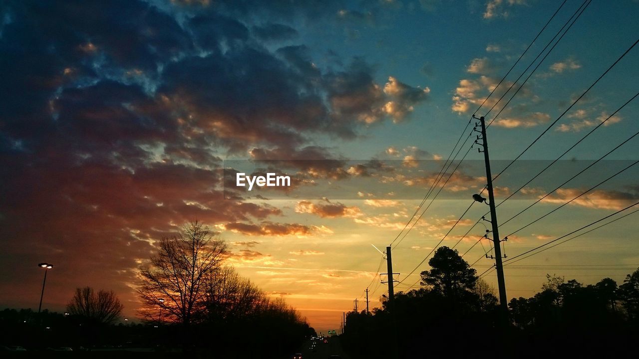 LOW ANGLE VIEW OF SILHOUETTE TREES AGAINST SKY AT SUNSET