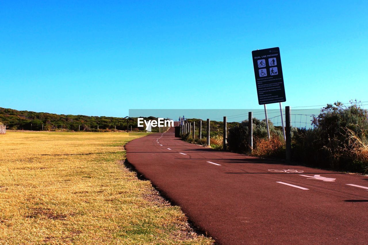 Empty road along countryside landscape