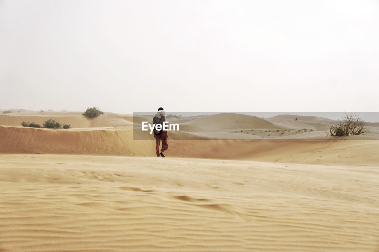 Full length of man walking at desert
