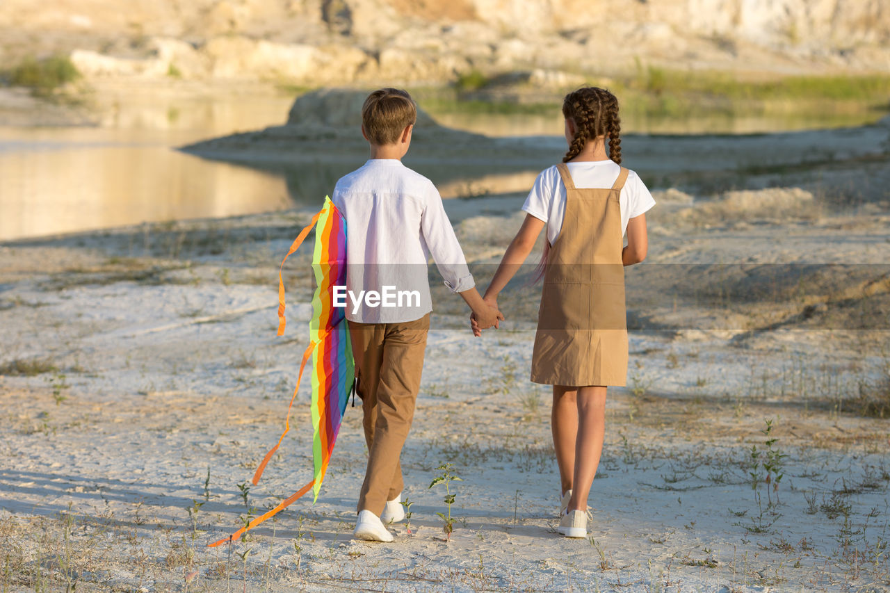 Walk of children 8-9 years old with a kite in the mountains.