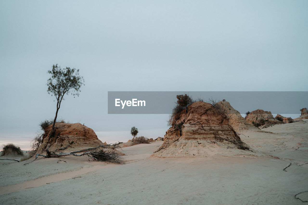 PANORAMIC VIEW OF ROCKS ON BEACH AGAINST SKY