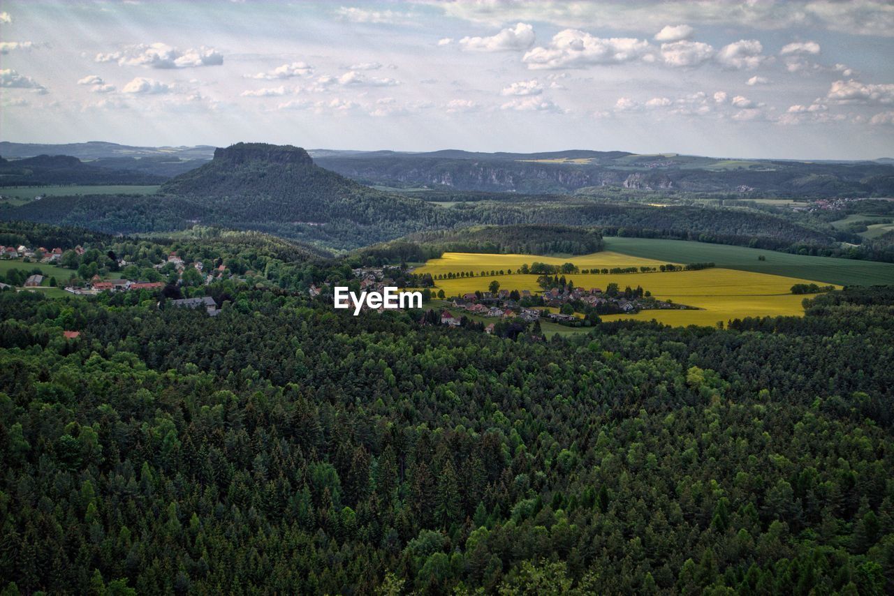 Scenic view of landscape by lilienstein mountain against sky