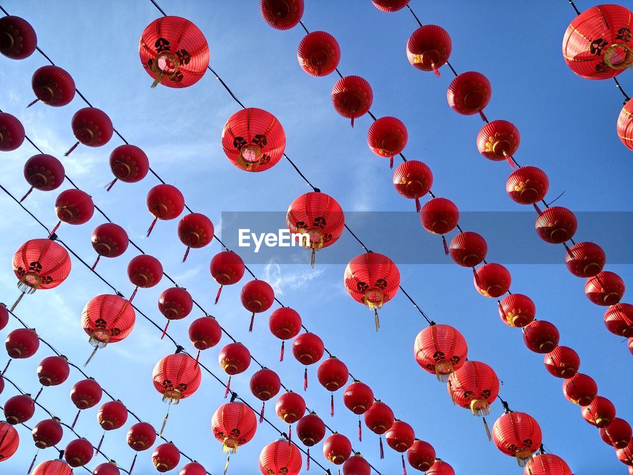 Low angle view of lanterns hanging against sky