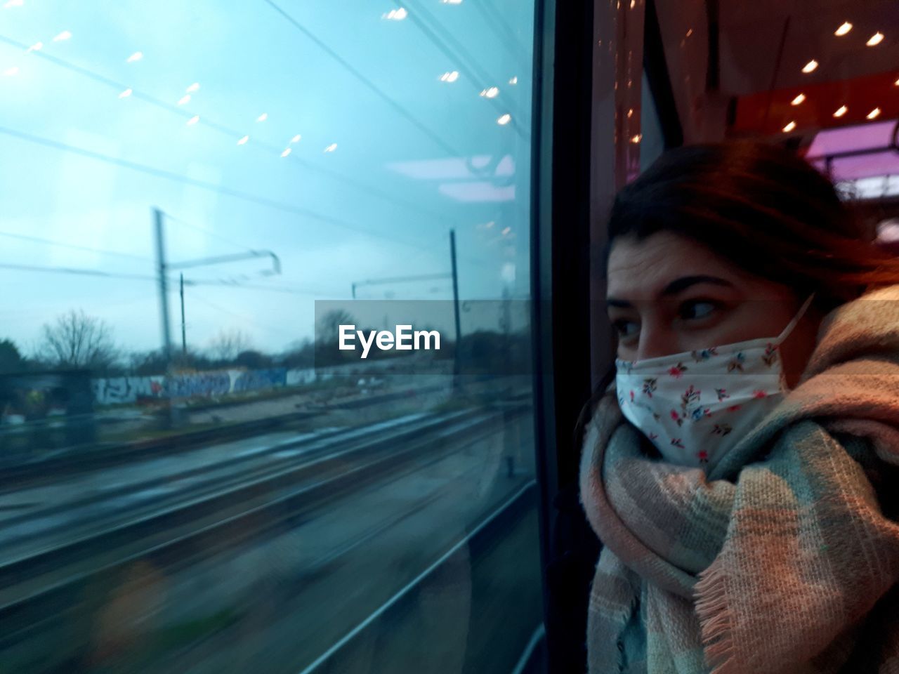 Woman looking away through train window