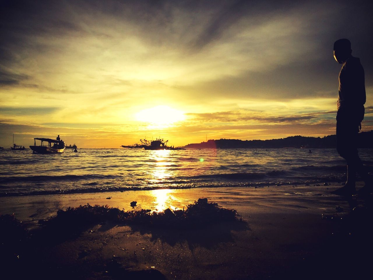 SILHOUETTE OF MAN ON BEACH