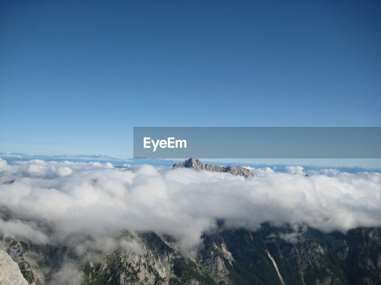 Scenic view of cloudscape on mountains against sky