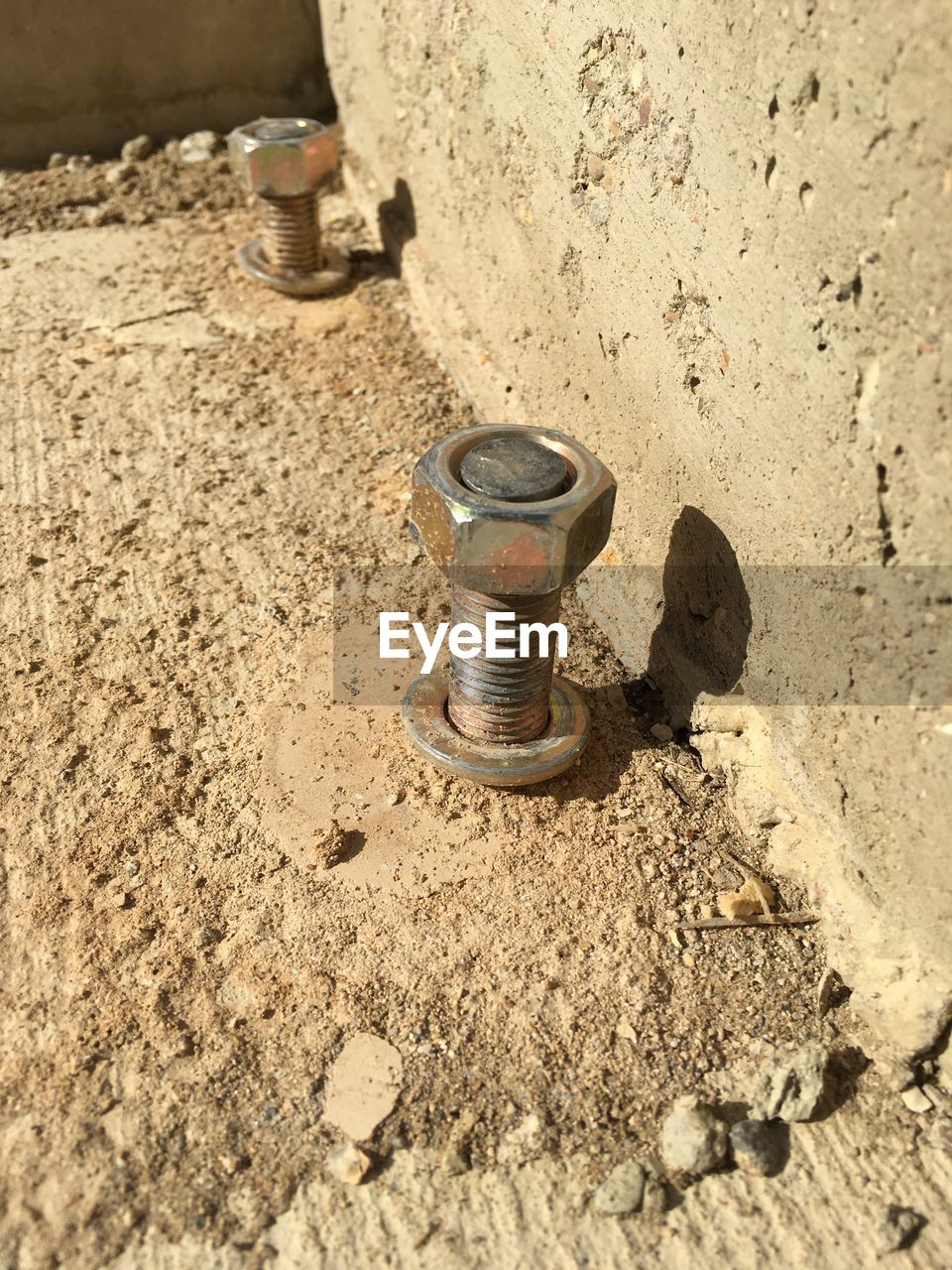 Close-up of metal on dirt road