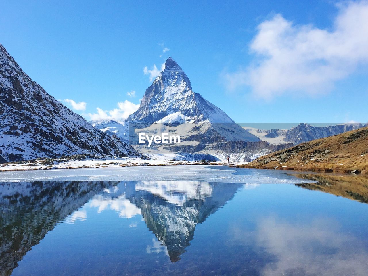 Scenic view of lake and mountains against sky