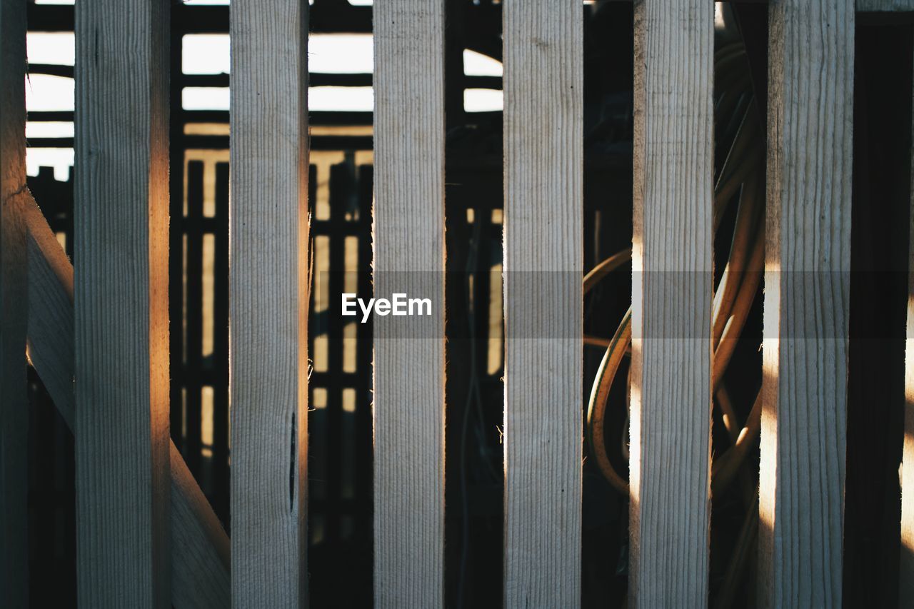 Close-up of wooden fence in sunset
