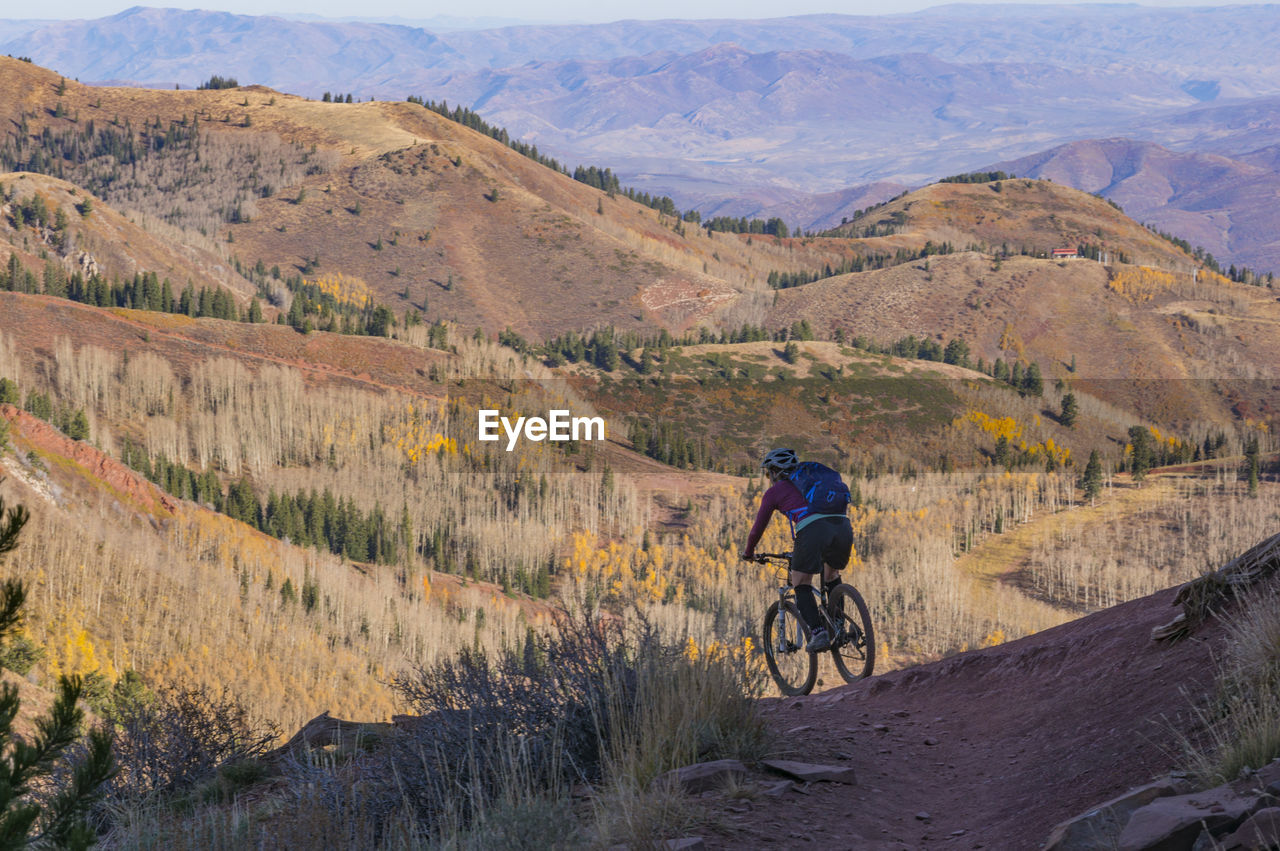 High angle view of man riding bicycle on mountain