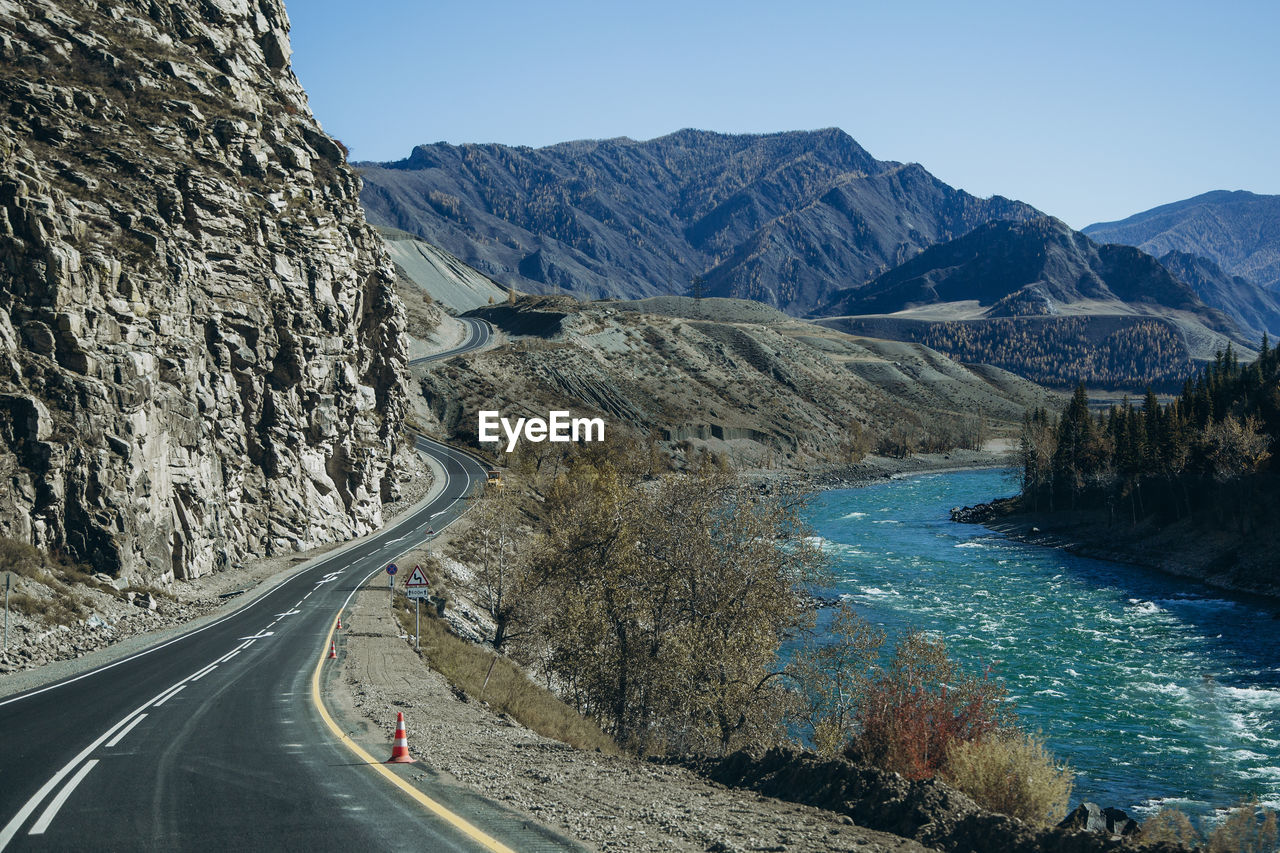 Road leading towards mountains against sky