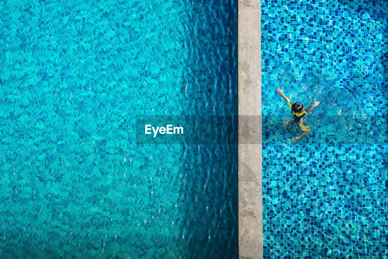 High angle view of child swimming in pool