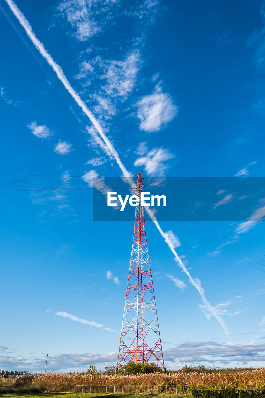 Low angle view of vapor trail against blue sky