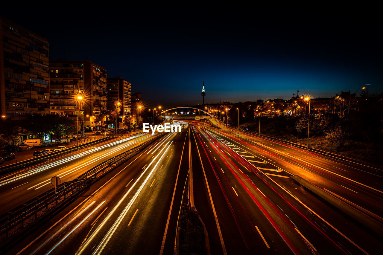 High angle view of light trails on road at night