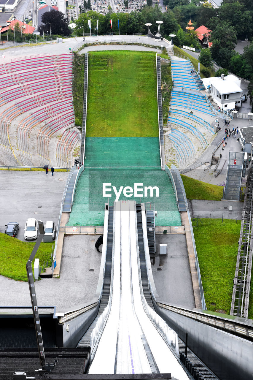 HIGH ANGLE VIEW OF EMPTY CHAIRS AGAINST TREES