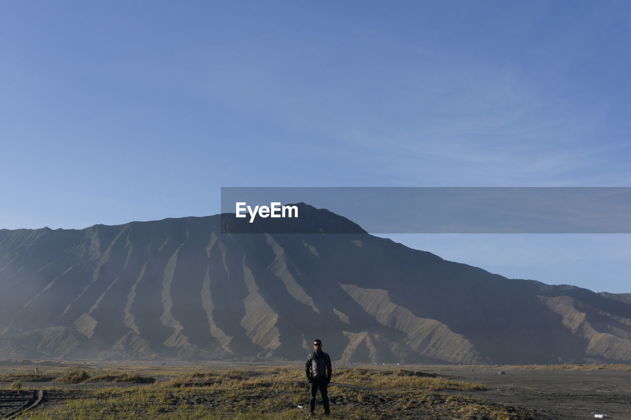 Full length of man standing on land against sky mount bromo