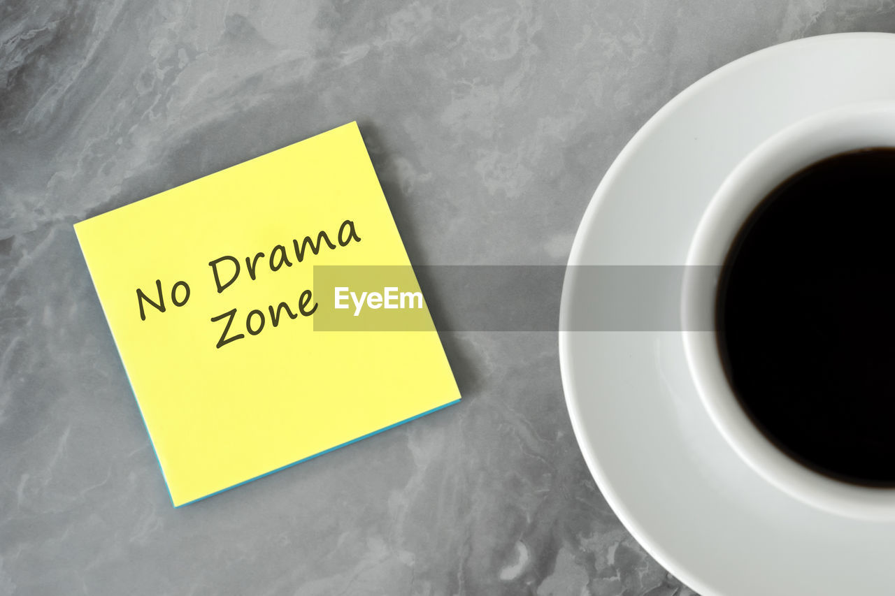 adhesive note, note, communication, food and drink, yellow, cup, mug, drink, indoors, coffee cup, text, coffee, table, no people, business, paper, refreshment, copy space, high angle view, message, close-up