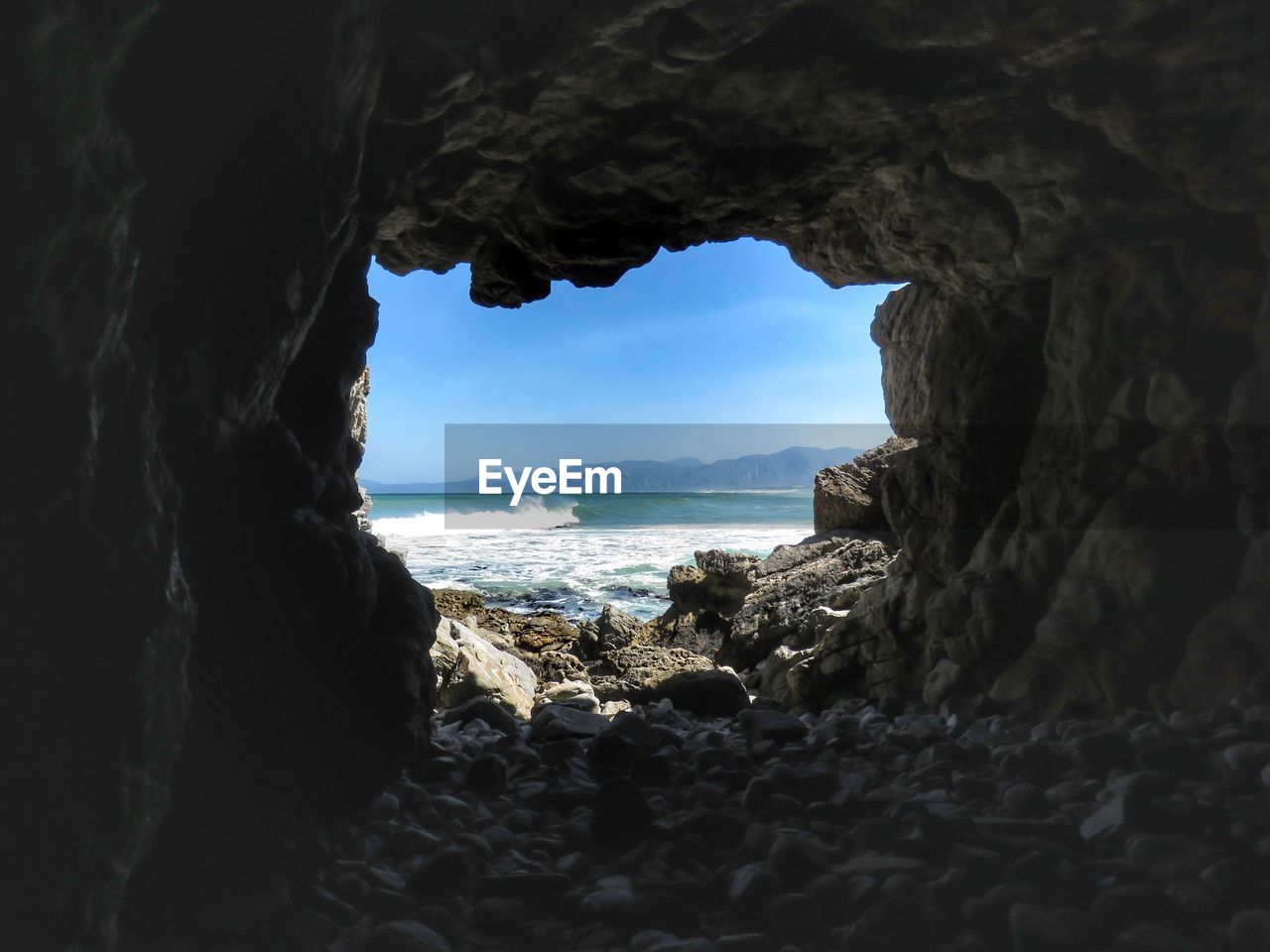 Scenic view of sea seen through cave