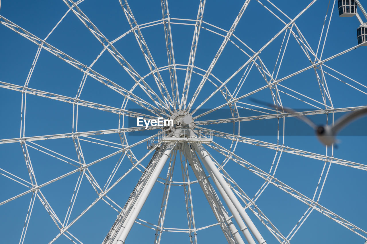 Full frame shot of ferris wheel against clear blue sky
