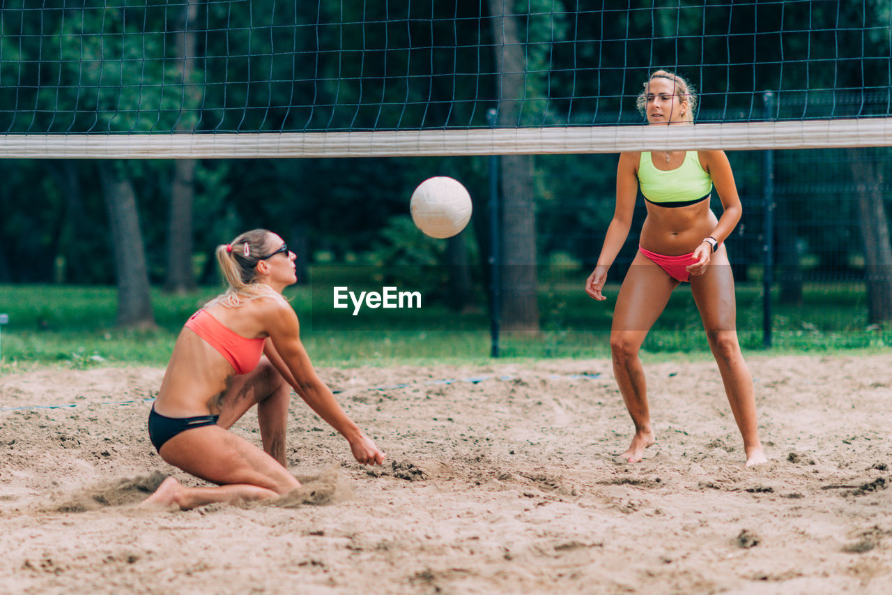 Beach volleyball player hitting the ball