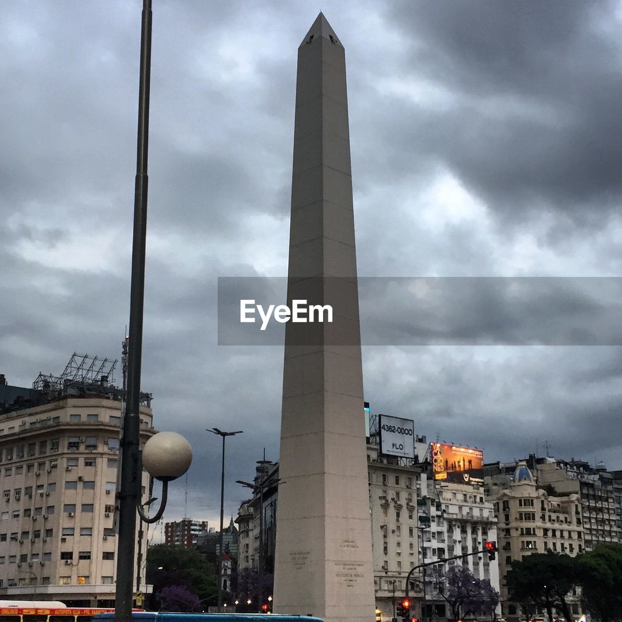 CITY BUILDINGS AGAINST CLOUDY SKY