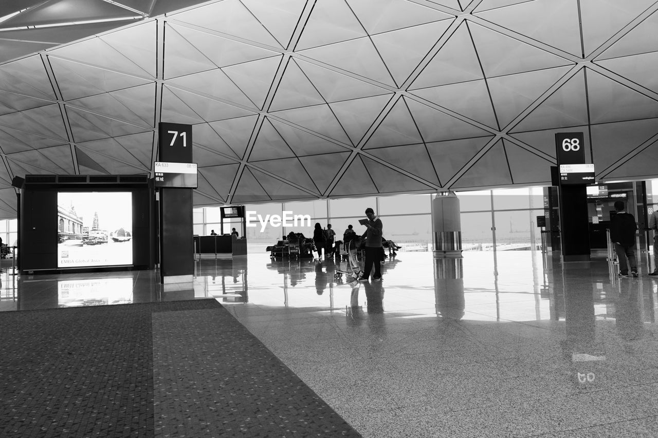 PEOPLE WALKING IN RAILROAD STATION PLATFORM