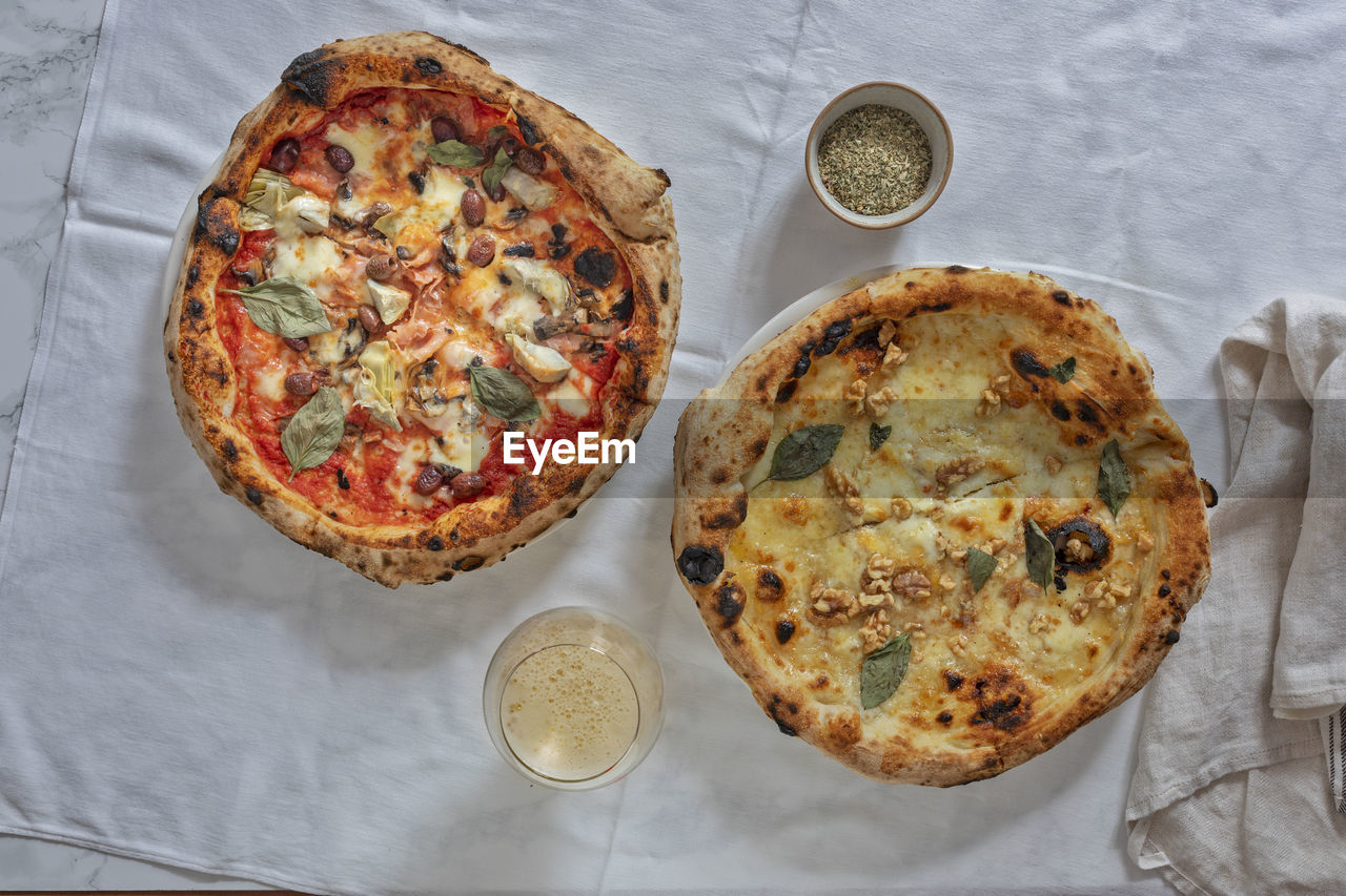 Two round pizzas from above.