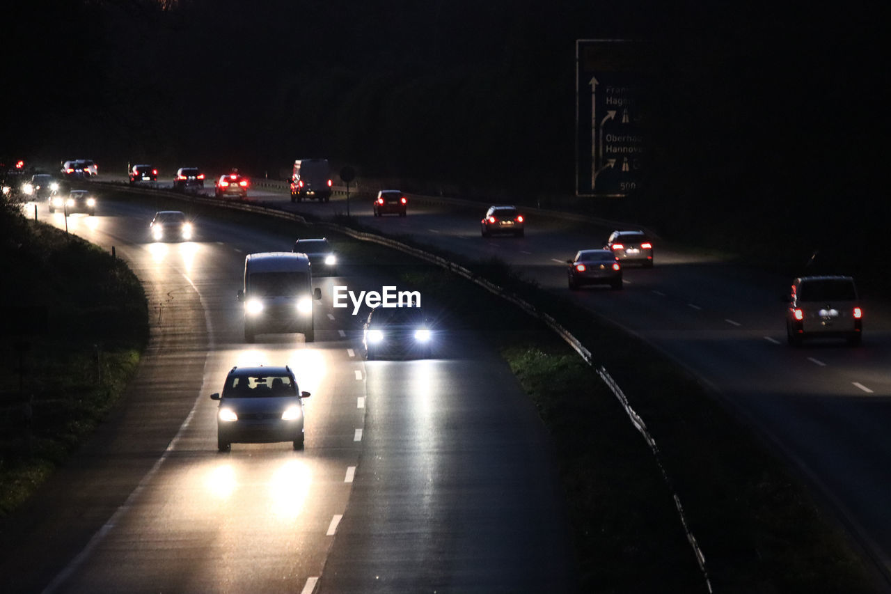 CARS ON HIGHWAY AT NIGHT
