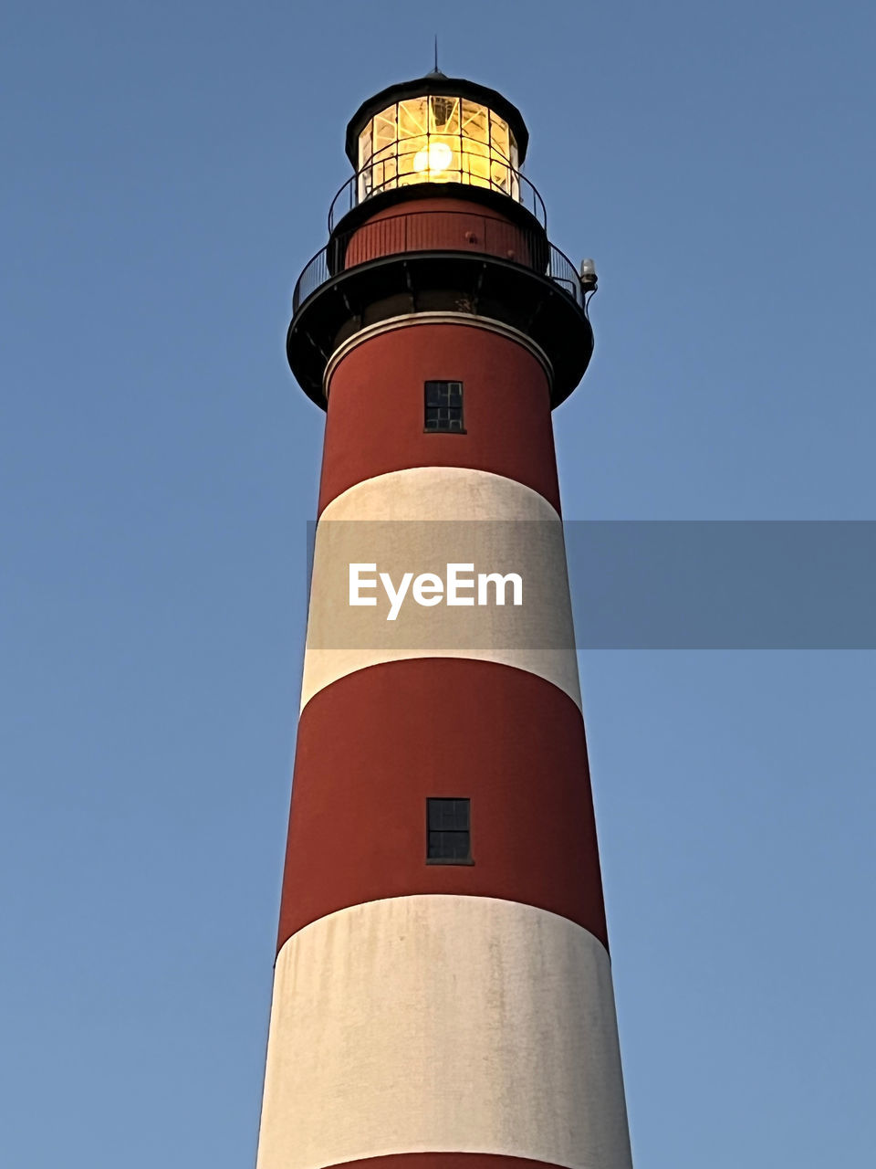 guidance, lighthouse, tower, architecture, protection, built structure, security, building exterior, building, sky, clear sky, blue, nature, no people, day, low angle view, outdoors, observation tower, surveillance, water, travel, communication, travel destinations, sunny, red