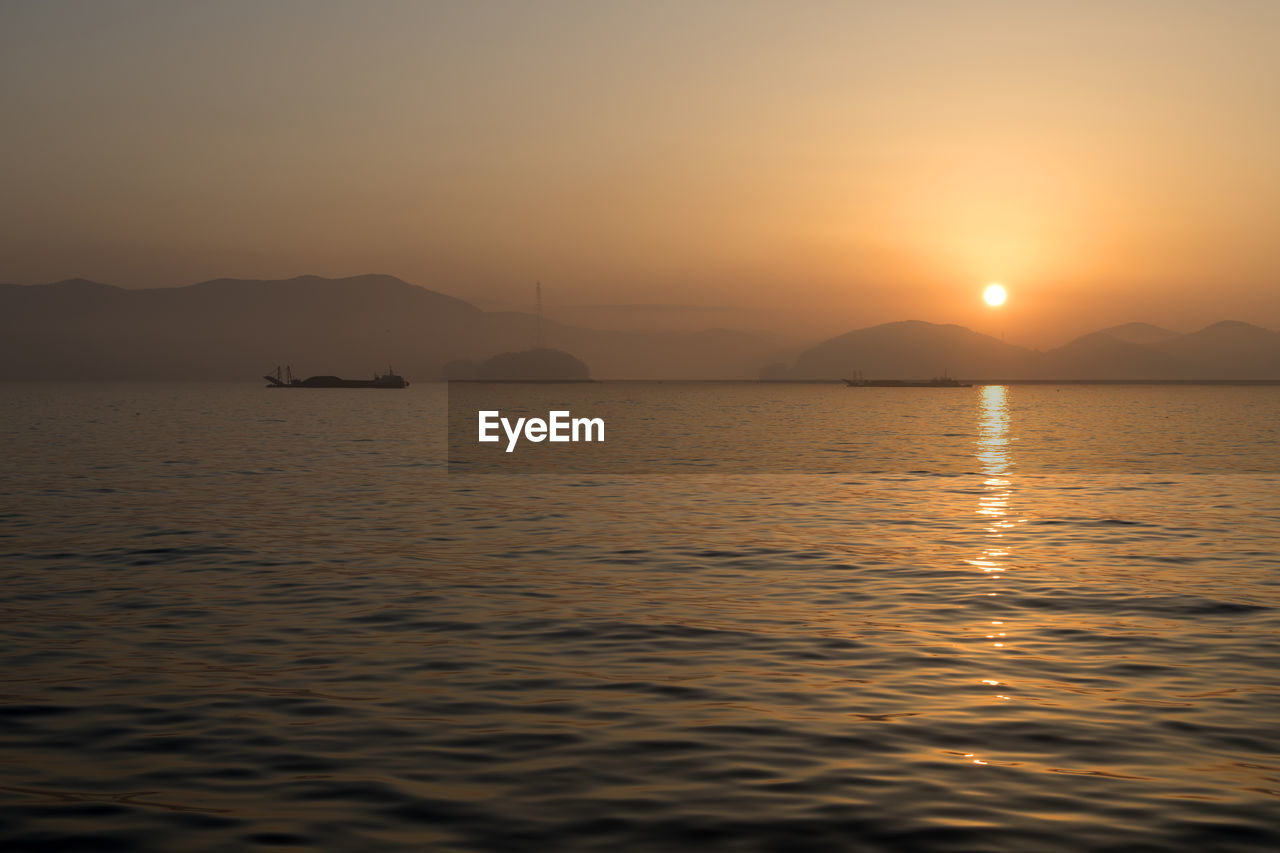 Scenic view of sea against clear sky during sunset