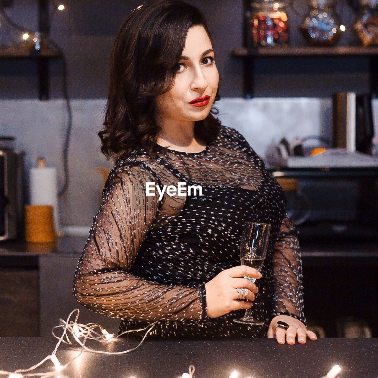 Portrait of woman having champagne in restaurant