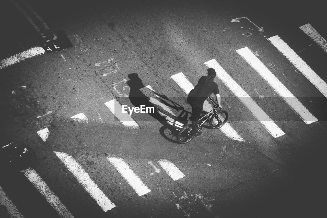 High angle view of man riding bicycle on street