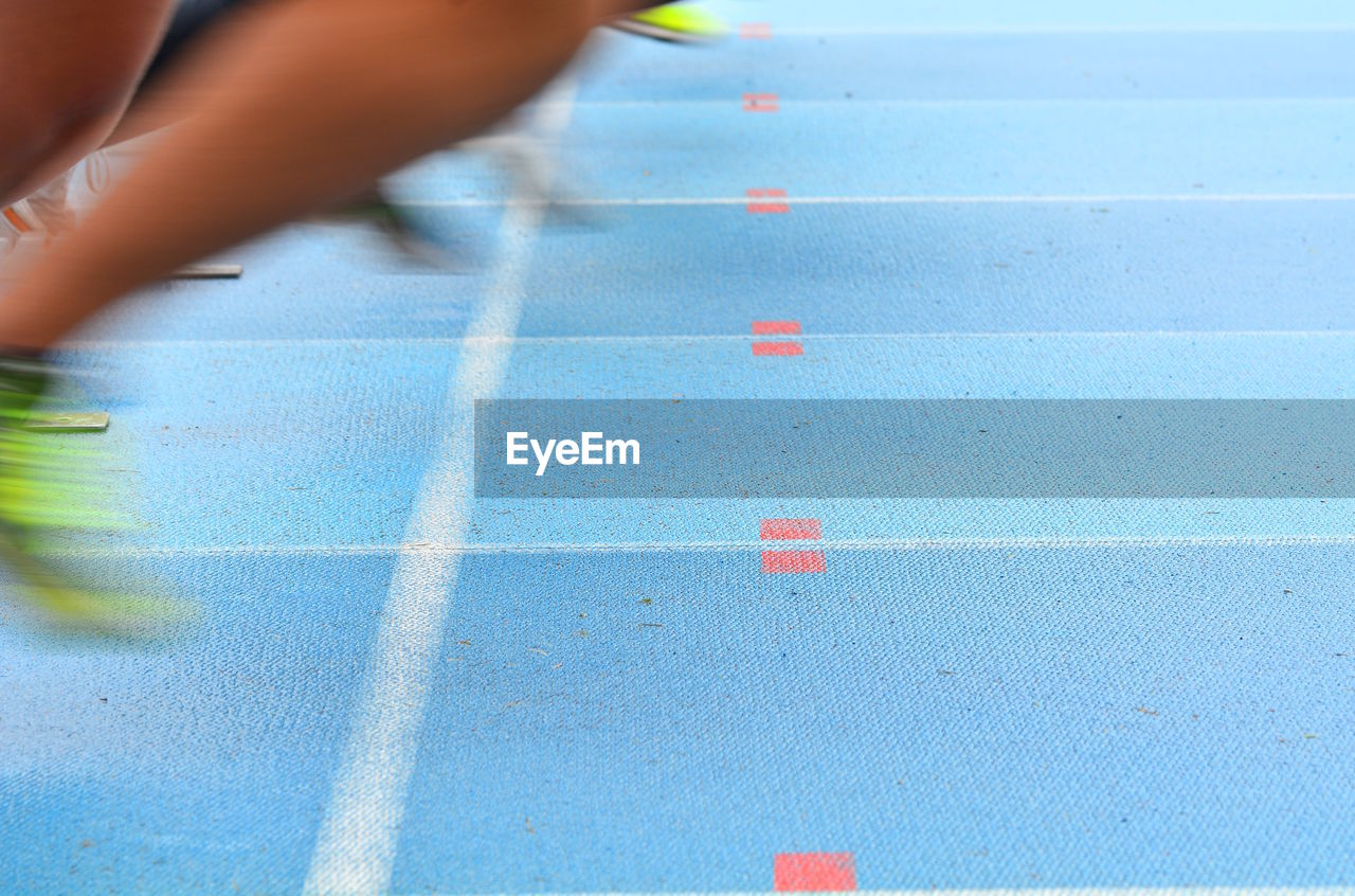 Low section of person running on track
