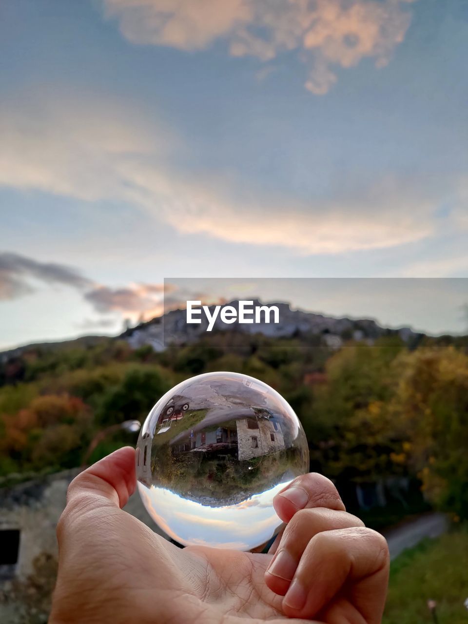 MIDSECTION OF PERSON HOLDING CRYSTAL BALL