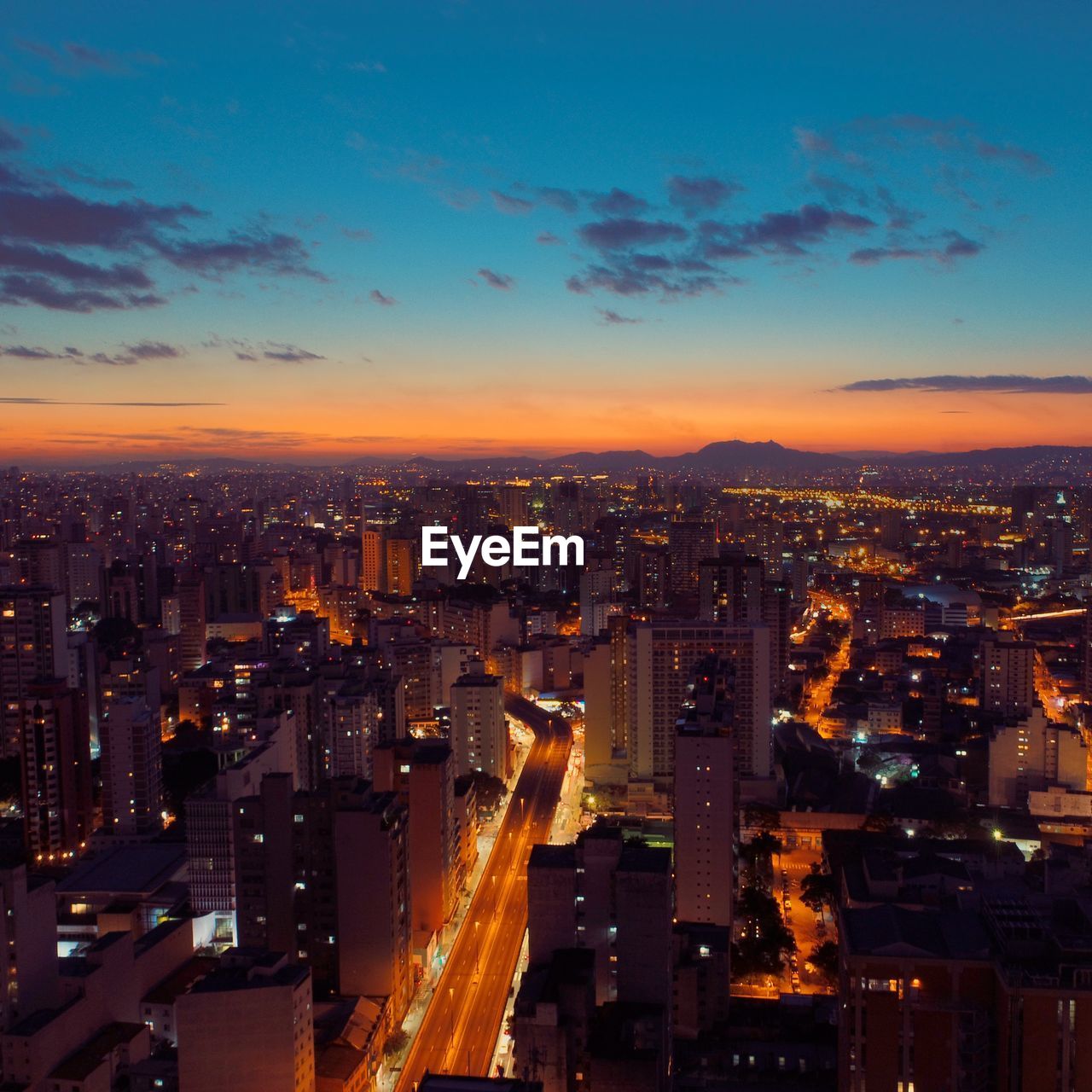 Illuminated cityscape against sky