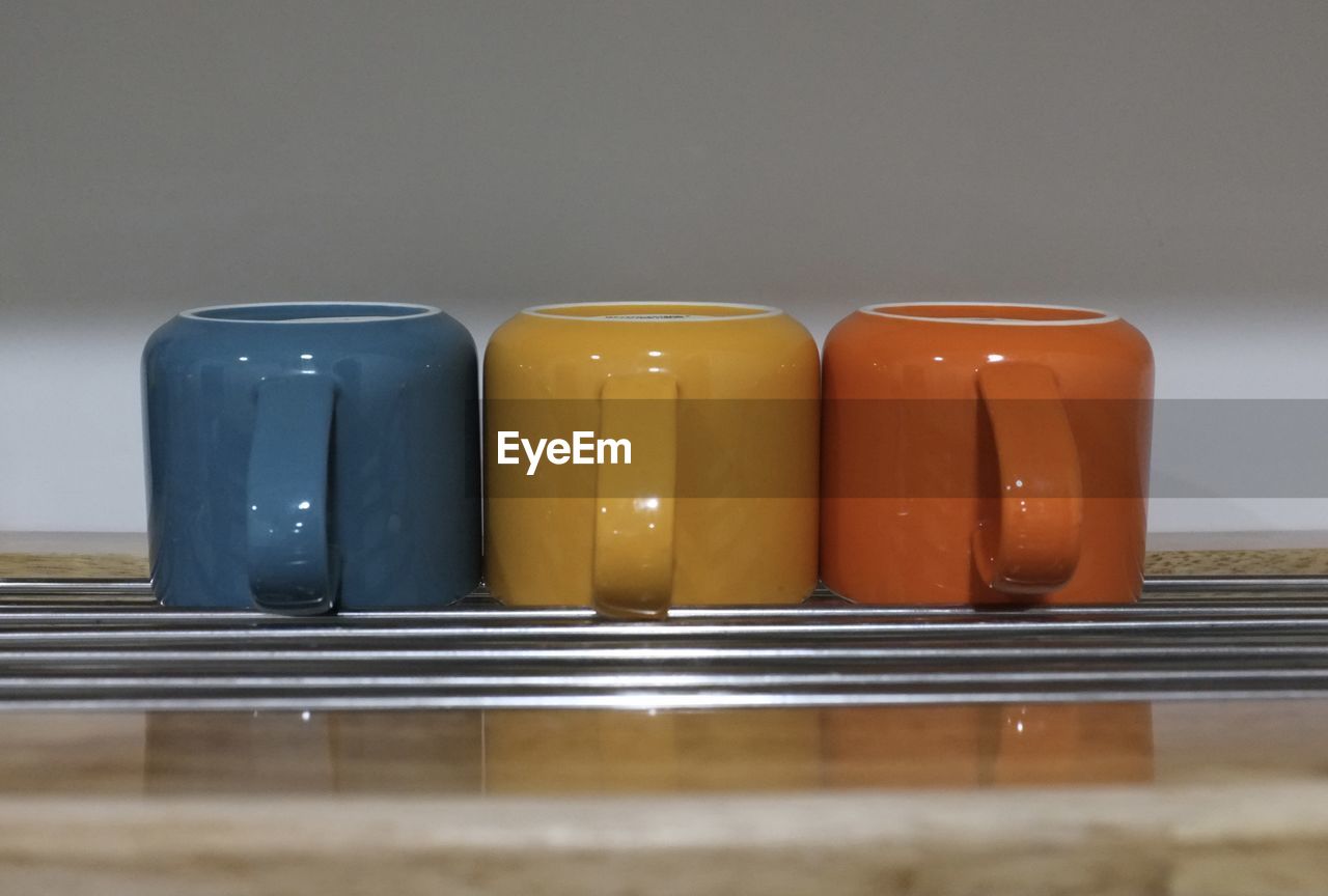 Close-up of colorful cups on table