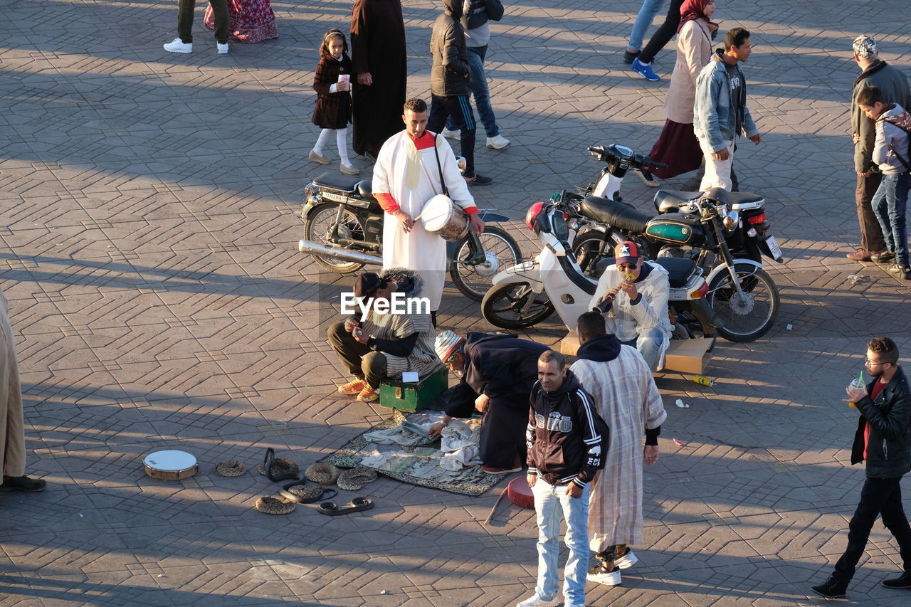 HIGH ANGLE VIEW OF PEOPLE ENJOYING ON STREET