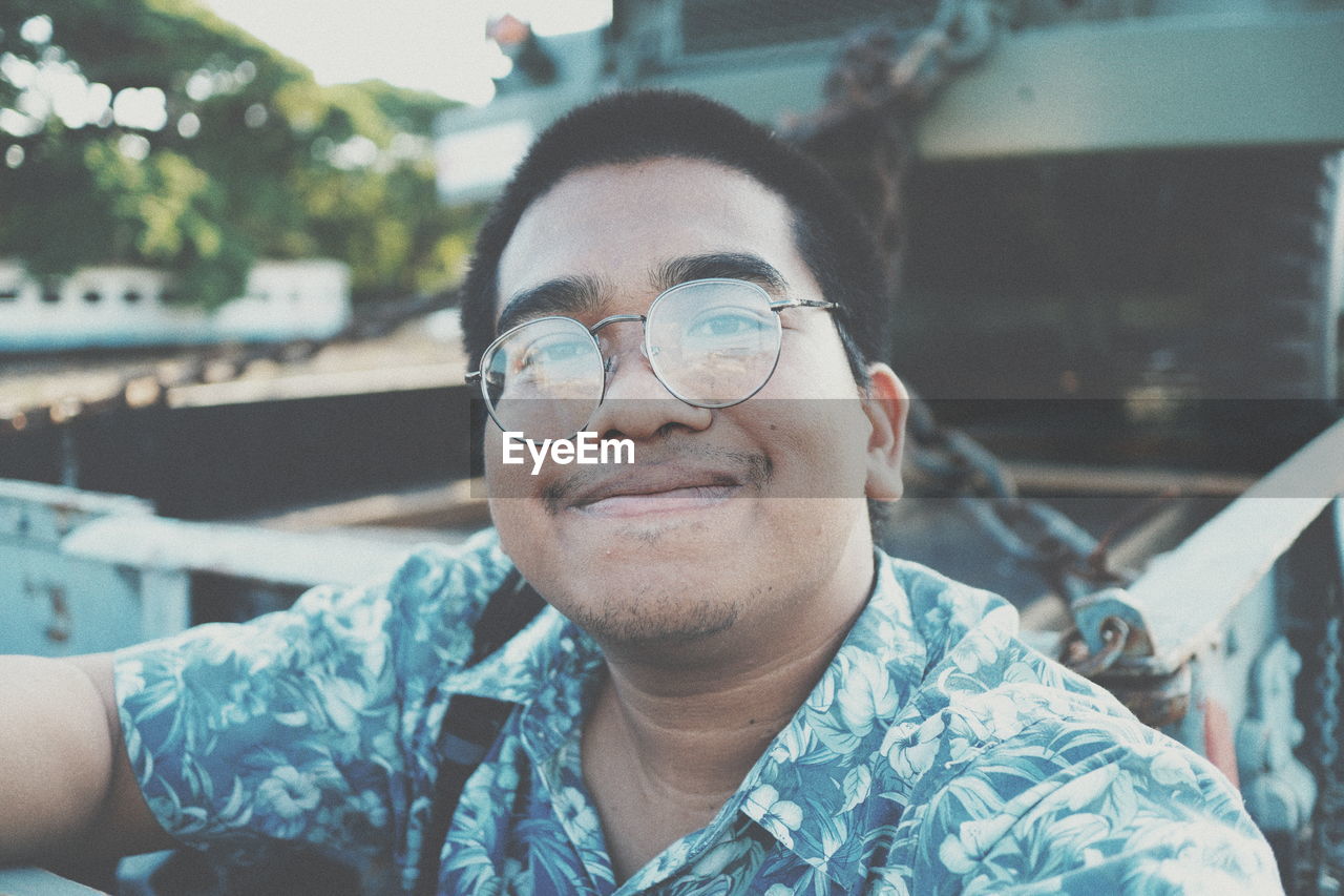 Portrait of smiling young man outdoors