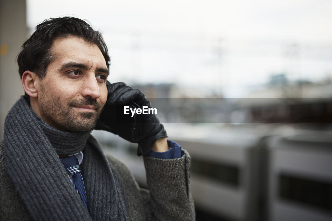 Businessman talking on phone outdoors