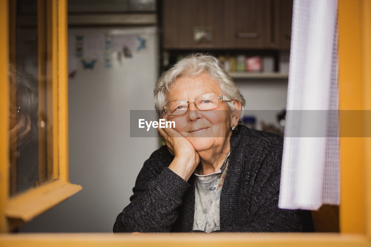 portrait of young man looking away at home