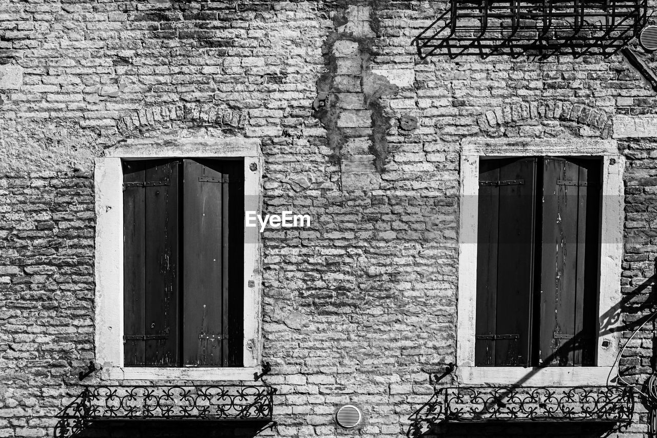 architecture, built structure, building exterior, window, building, black and white, house, door, no people, monochrome, entrance, monochrome photography, closed, day, white, black, residential district, wall - building feature, wall, old, brick wall, brick, outdoors, facade, security, home, protection, abandoned