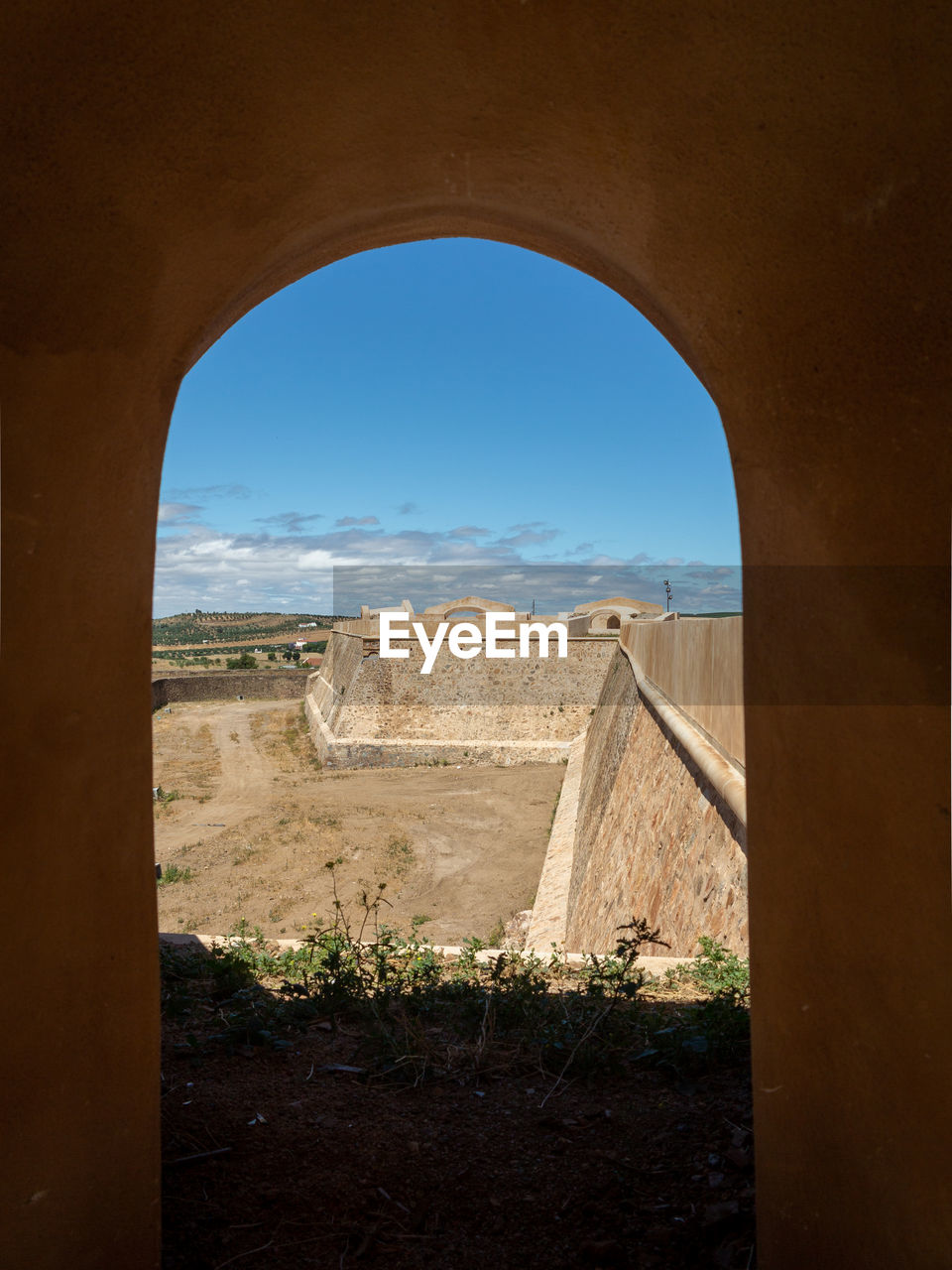 VIEW OF OLD RUIN THROUGH WINDOW